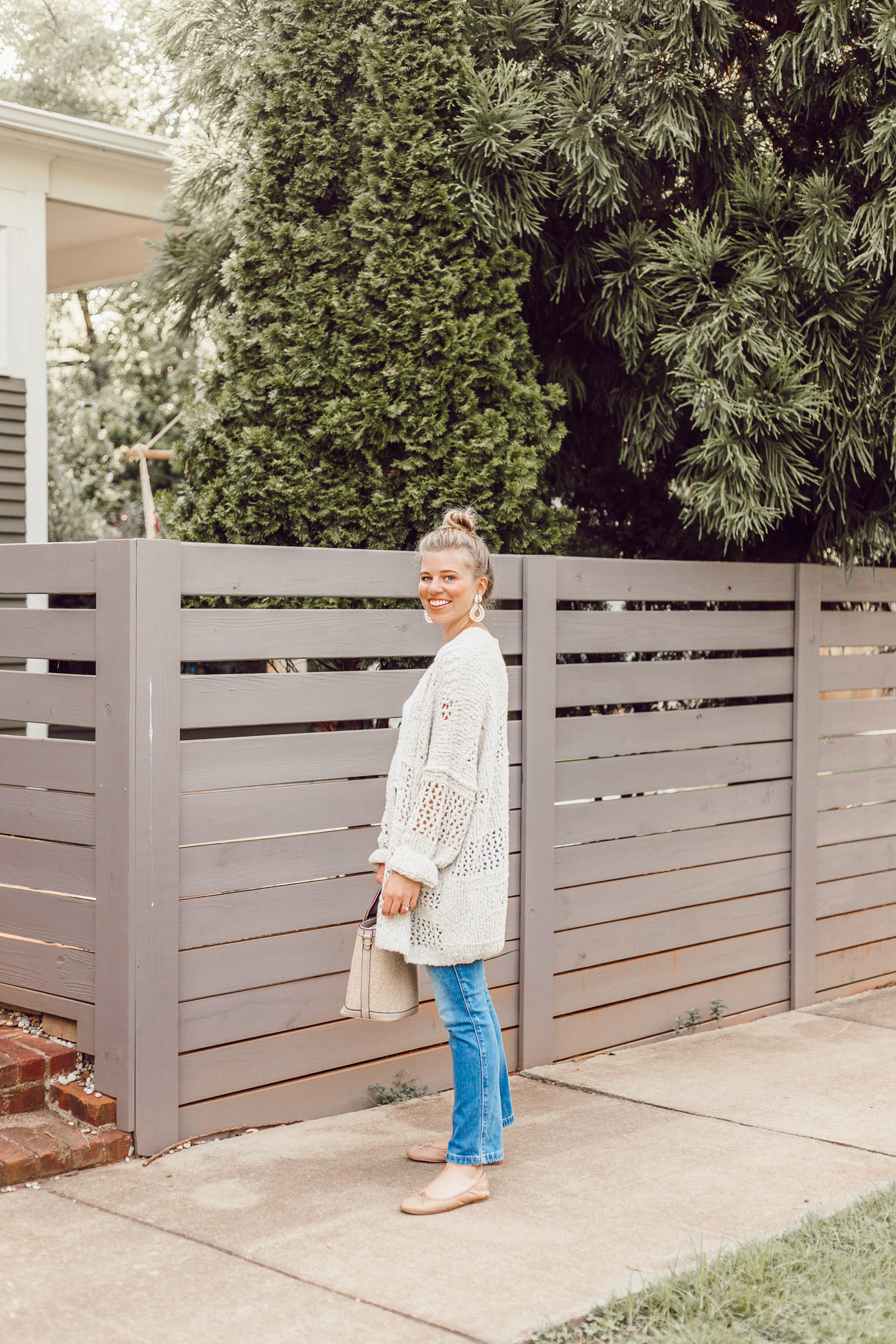 Laura Leigh of Louella Reese transitions a basic white tee and jeans combination into fall with a Free People Crochet Cardigan