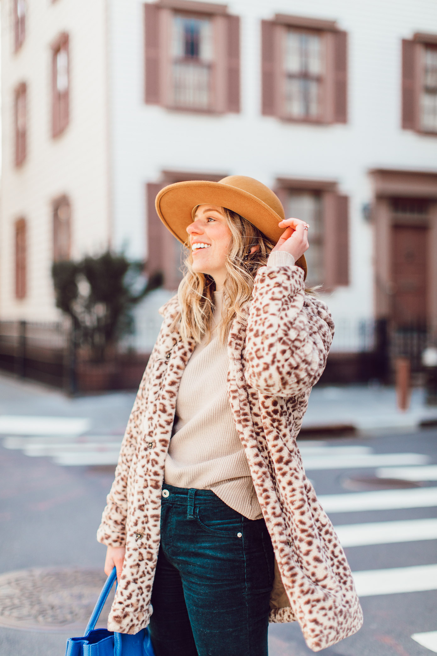 Winter Wardrobe Basics | Retro Outfit Idea - Faux Fur Leopard Coat, Corduroy Pants, Bright Blue Leather Tote, Bronze Felt Hat, White Booties featured on Louella Reese