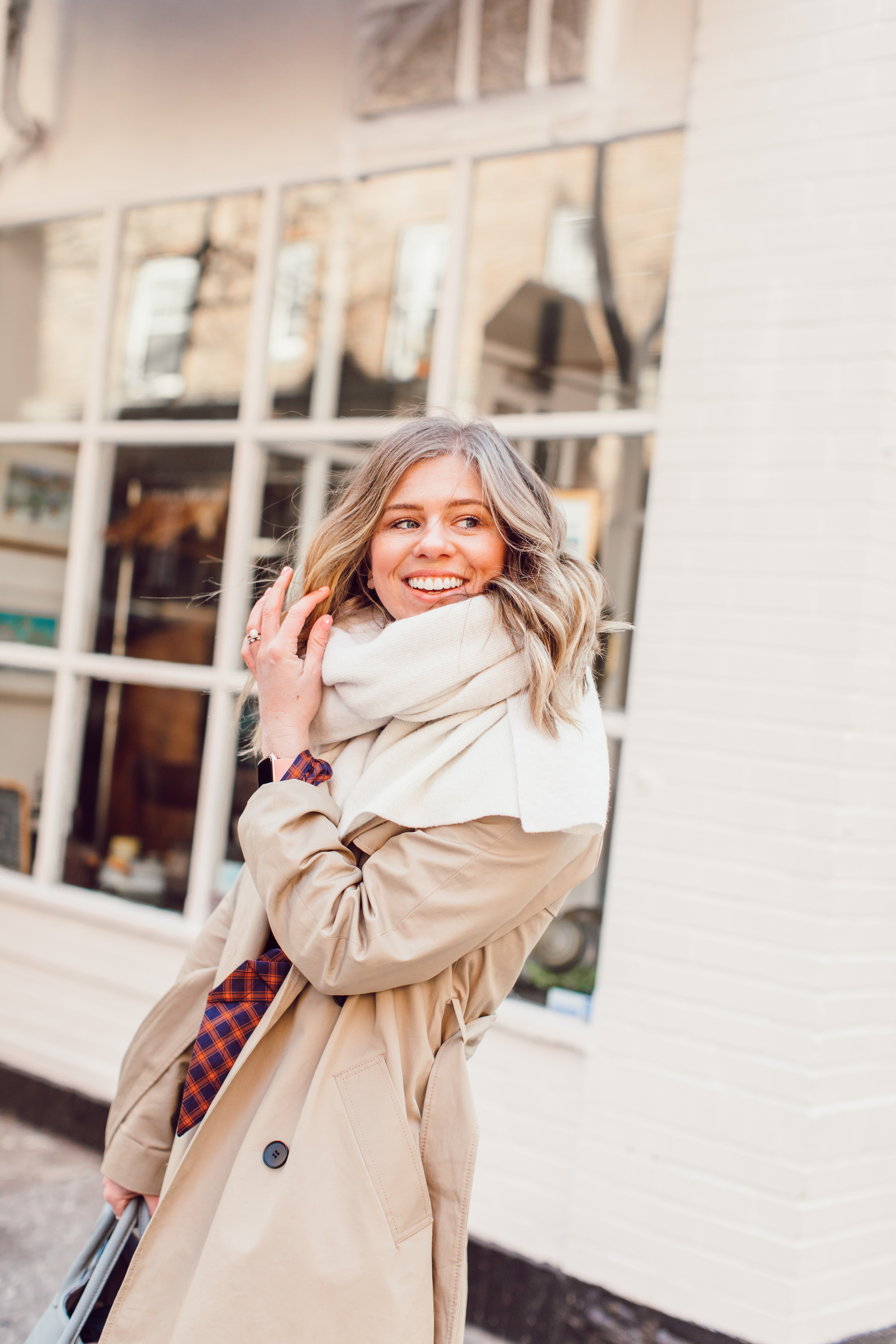 The Perfect Trench Coat styled by top US fashion blogger Laura Leigh of Louella Reese; Image of woman wearing Everyone Drape Trench Coat, & Other Stories Plaid Midi Dress, Marc Fisher LTD Belle Booties, Zac Beck Bags Medium Classic Tote | How to Style a Trench Coat for Winter